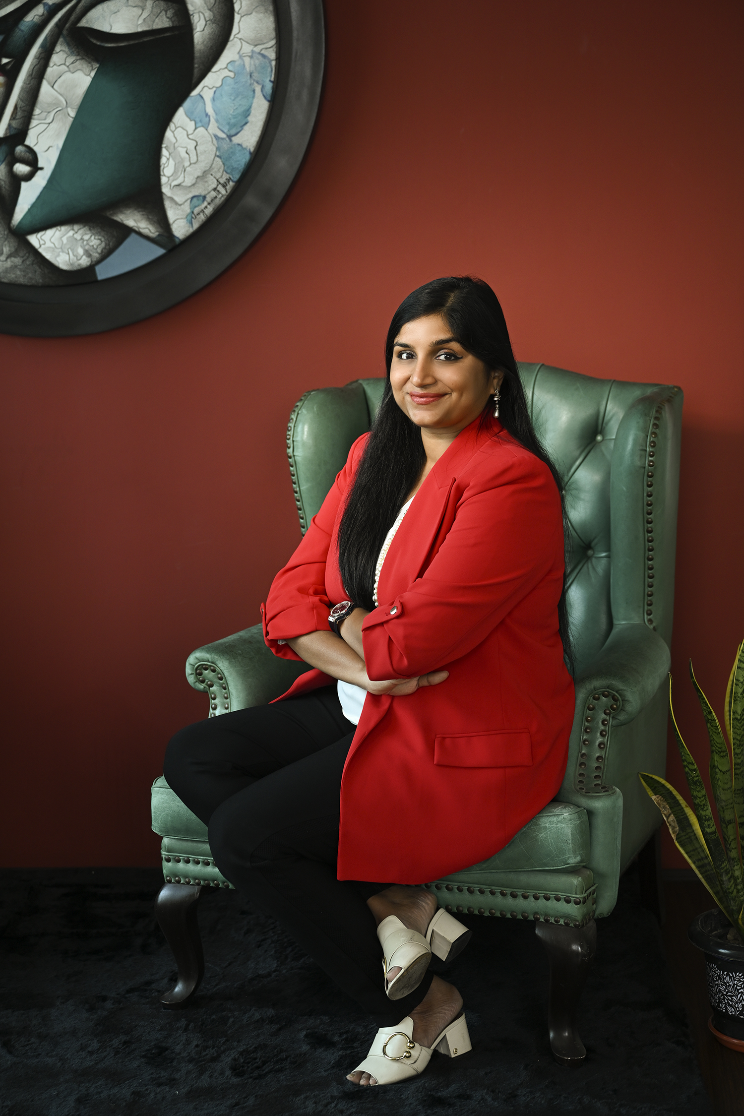 Aradhana Dalmia, founder of The Artemist, before a gallery wall of works