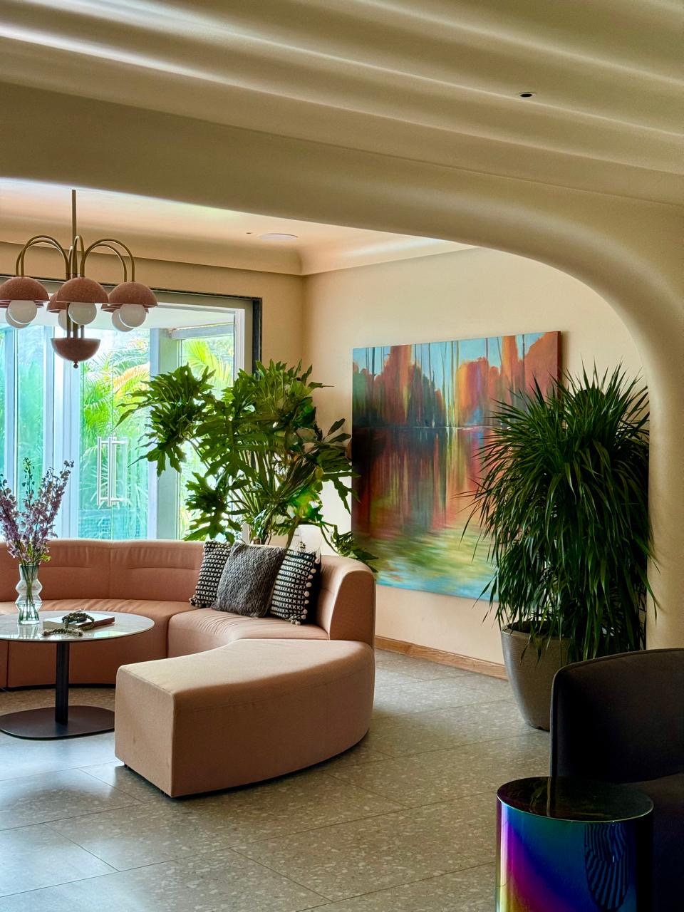 A residential lounge with a large abstract painting and pink velvet seating — Bespoke commission, The Artemist